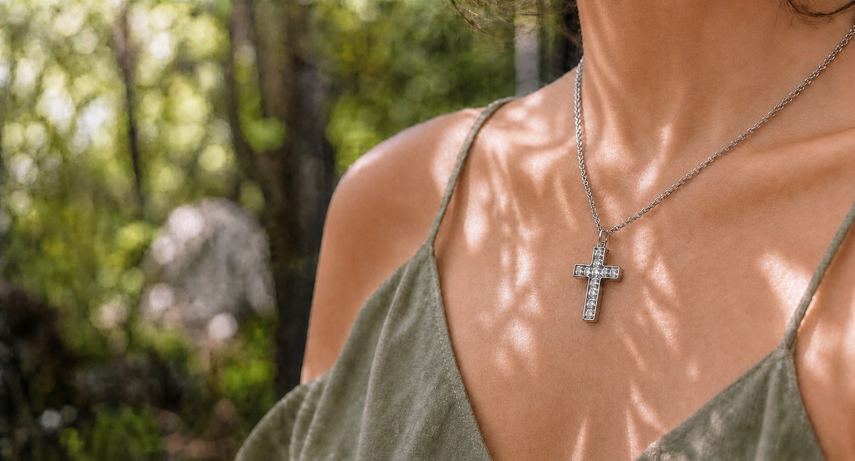 Woman wearing the white zirconia Aurevyn Grid NFC cross necklace outdoors